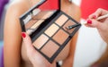 Makeup professional artist applying eyeshadow on woman model Royalty Free Stock Photo