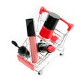 Makeup in pushcart on white background. Red lipstick, mascara, pink lip gloss, powder, nail polish. Makeup products in sh Royalty Free Stock Photo