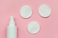 Makeup removing, white facial cotton pads and bottle of micellar water, woman skin and body care product isolated on pastel pink b Royalty Free Stock Photo