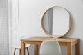 Makeup room interior with wooden table and mirror near wall Royalty Free Stock Photo