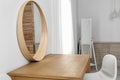 Makeup room interior with wooden table and mirror near wall Royalty Free Stock Photo