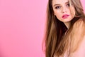 Makeup for sensual model with soft skin. woman with long hair on pink background. Beauty and hairdresser salon Royalty Free Stock Photo