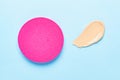 Makeup sponge for foundation cream, samples on blue color background. Skincare beauty blender. Flat lay swatches from tone cream Royalty Free Stock Photo