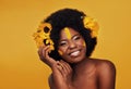 Makeup, sunflower and portrait of black woman in studio for beauty, creative or spring. Natural, cosmetics and floral Royalty Free Stock Photo