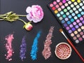 Makeup tools and accessories isolated on black background. Top view and mock up. eye shadows, make up brushes and decorative flowe Royalty Free Stock Photo