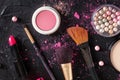 Makeup tools and products, shot from the top on a black background Royalty Free Stock Photo