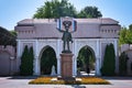 Small Lenin statue with pink Triumphal Arch in Makhachkala