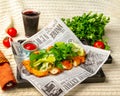 Makhachkala, Dagestan, RUS, May 17, 2019 Sliced deep-fried chicken breast decorated with chopped herbs, lettuce and spinach on a Royalty Free Stock Photo