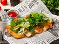 Makhachkala, Dagestan, RUS, May 17, 2019 Sliced fried chicken breast garnished with chopped herbs, lettuce and spinach on a Royalty Free Stock Photo