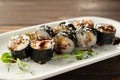 Maki rolls with eel, sesame seeds and soy sauce on a white plate. japanese food with sushi roll. Royalty Free Stock Photo