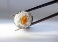 Maki (Sushi Roll) on chopstick Royalty Free Stock Photo