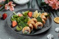 Maki Sushi - a roll of cream cheese, strawberries, avocado and fried salmon. Summer seasonal sushi rolls Royalty Free Stock Photo