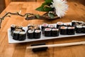 Maki Sushi rolls with salmon, tuna, eel and avocado on a white plate. close up. Royalty Free Stock Photo