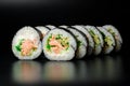 Maki sushi rolls with tuna, cream cheese, cucumber, rice and nori, isolated on black Royalty Free Stock Photo