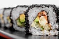 Maki Sushi set on dark pattern background. Sushi Set nigiri, rolls and sashimi served in black square plate Royalty Free Stock Photo