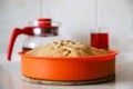 Making apple pie at home. Homemade pastry in silicone cake pan served with cherry fruit drink Royalty Free Stock Photo