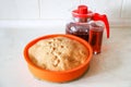 Making apple pie at home. Homemade pastry in silicone cake pan served with cherry fruit drink Royalty Free Stock Photo