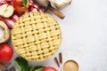 Raw unbaked apple pie with tools and ingredients for cooking Royalty Free Stock Photo