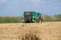 making bales tractor working in rice harvest season