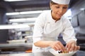 Making beautiful dishes. a chef preparing dessert in a professional kitchen. Royalty Free Stock Photo