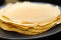 Making bliny at home. Closeup of traditional tasty thin pancakes. Photo with selective focus and copy space