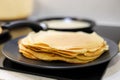 Making bliny at home. Closeup of traditional tasty thin pancakes. Photo with selective focus