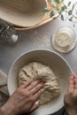 Making bread wheat with sourdough starter. Homemade breadmaking, female hand over white bowl cooking bread. Royalty Free Stock Photo