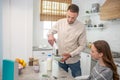 Dad and daughter in the kitchen during breakfast.