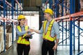 Making a business deal. A man and a woman, well dressed in an elegant suit with a protective yellow helmet Royalty Free Stock Photo