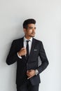 Making business look good. Confident young man in formal wear looking away while standing against grey background.