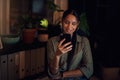 Making business plans via text. a young businesswoman using a cellphone in an office at night. Royalty Free Stock Photo