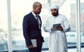 Making business success a collaborative effort. two businessmen using a digital tablet while having a discussion in a