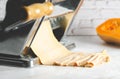Making butternut squash noodles with a pasta maker machine.