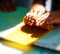 Making candle from honey bee wax plate at market. Royalty Free Stock Photo