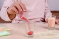 Making candles by yourself . Little girl making candle in the glass from soy wax parsley flakes. Royalty Free Stock Photo