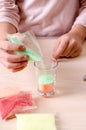 Making candles by yourself . Little girl making candle in the glass from soy wax parsley flakes Royalty Free Stock Photo