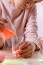 Making candles by yourself . Little girl making candle in the glass from soy wax parsley flakes Royalty Free Stock Photo