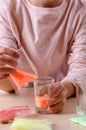 Making candles by yourself . Little girl making candle in the glass from soy wax parsley flakes Royalty Free Stock Photo