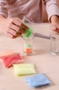 Making candles by yourself . Little girl making candle in the glass from soy wax parsley flakes Royalty Free Stock Photo
