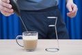 Making cappuccino coffee with a mixer at home Royalty Free Stock Photo