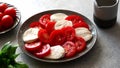 making caprese salad with mozzarella, tomatoes and basil. Classic caprese salad. Italian caprese. Traditional italian