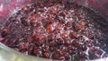 Making cherry jam at home; Add the sugar and lemon to the cherry and boil for one hour on the stove.