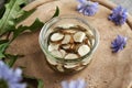 Making chicory root tincture in a glass jar on a table Royalty Free Stock Photo