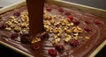 Making Chocolate Bark: Melted Dark Chocolate, Walnuts and Candied Cherries on Baking Sheet Royalty Free Stock Photo