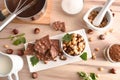 Making chocolate with hazelnuts on a wooden kitchen bench Royalty Free Stock Photo