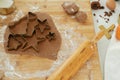 Making christmas gingerbread cookies. Gingerbread dough with festive golden metal cutters on wooden board with flour, cooking Royalty Free Stock Photo