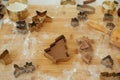 Making christmas gingerbread cookies. Gingerbread dough with festive golden metal cutters on wooden board with flour, cooking Royalty Free Stock Photo