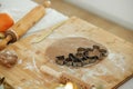 Making christmas gingerbread cookies. Gingerbread dough with festive metal cutters on wooden board with flour, cooking spices, Royalty Free Stock Photo