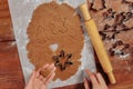 Making Christmas gingerbread in the different form. cutting man shapes in cookie dough Royalty Free Stock Photo