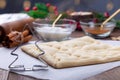 Making Christmas tree shaped puff pastry cookies with sugar and cinnamon, cutted dough on table